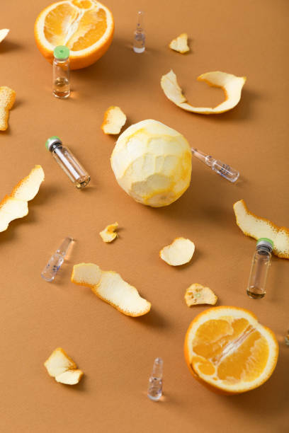 istock Ampoules with vitamin for immunity and orange fruit. 1302412664