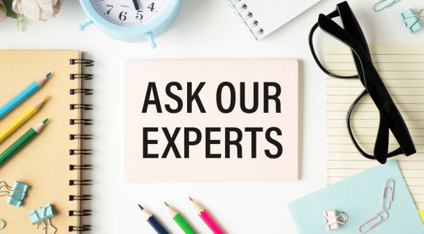 istock Businessman putting a card with text Ask our Expert 1302413471
