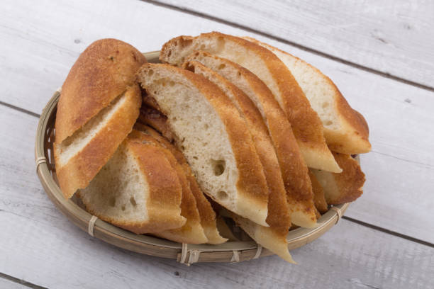 istock The cut baguette bread isolated on a basket. 1302413925