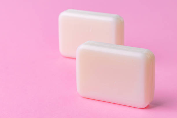istock Soap bar isolated on pink background. Close up. 1302416187