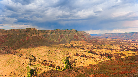 Aerial view of cliffs in desert landscape against cloudy sky, Grand Canyon National Park, Arizona, USA.