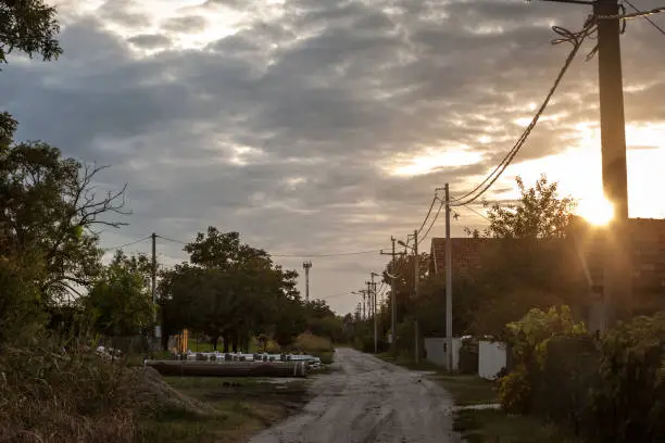 Picture of an unpaved road and dirtpath in the village of Ovca, in Serbia, at dusk. Ovca is a suburban settlement of Belgrade, the capital of Serbia. It is located to the northeast of the city, in the municipality of Palilula.