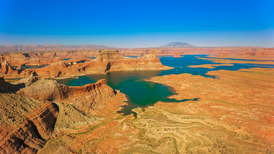 The Chains, Glen Canyon, Arizona. Red rocks, Lake Powell and cloudy sky background, copy space