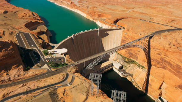 Aerial view Glen Canyon Dam and Glen Canyon Dam Bridge Aerial view of Glen Canyon Dam and Glen Canyon Dam Bridge over Lake Powell, Glen Canyon National Recreation Area, Coconino County, Page, Arizona, USA. glen canyon dam stock pictures, royalty-free photos & images