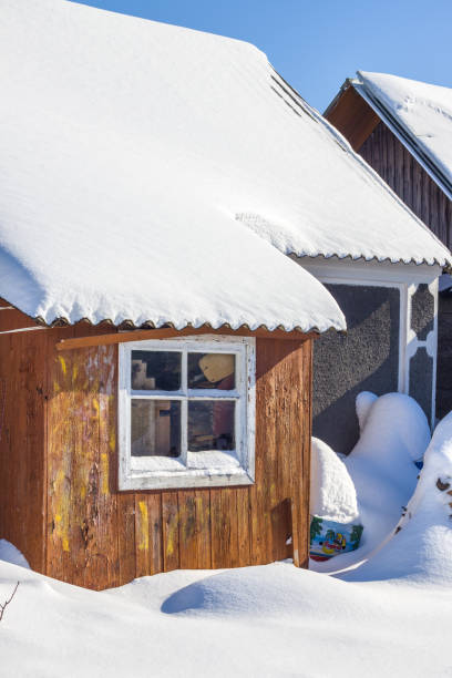 istock winter snow covered old house 1302417148