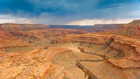 Aerial view of cliffs in desert landscape against cloudy sky, Grand Canyon National Park, Arizona, USA.