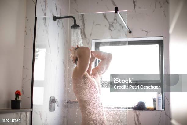A Caucasian Adult Male Taking A Shower At Home Stock Photo - Download Image Now - Shower, Heat - Temperature, Only Men