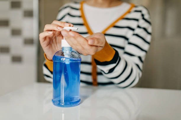 istock Young woman applying hand sanitiser 1302418229