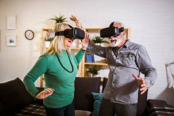 istock Senior couple play virtual reality glasses headset playing video game 1302420505