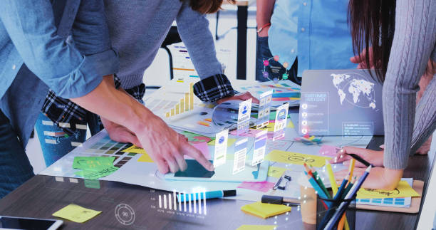 Close up ux developer and ui designer use augmented reality app brainstorming about mobile interface wireframe design on desk at modern office.Creative digital development agency stock photo