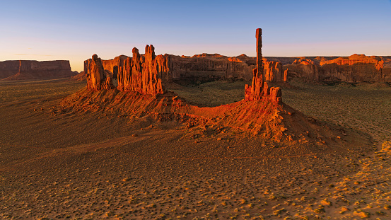 Aerial view of The Gossips and Totem Pole on desert landscape in Monument Valley, Arizona, USA.