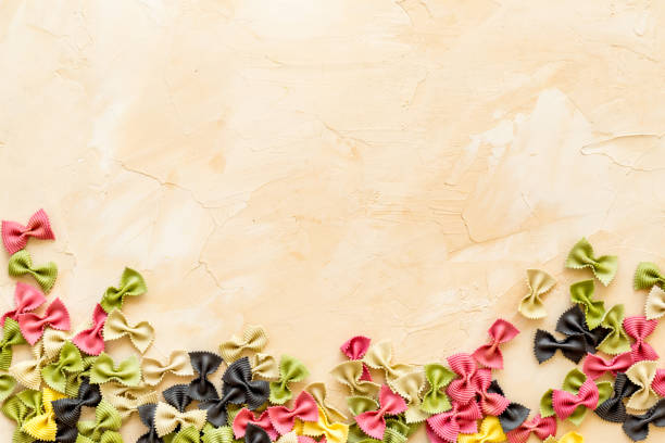 istock Heap of colored farfalle pasta, top view 1302423570