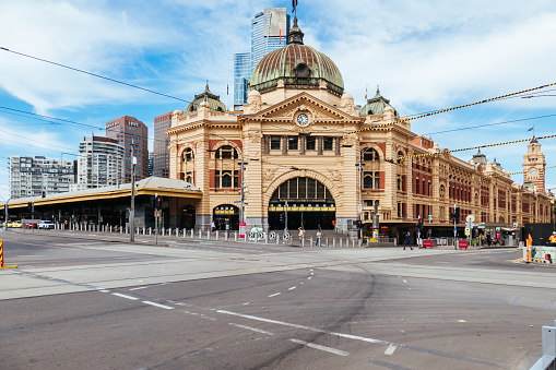 Melbourne, Australia - February 16 2021: Flinders St station within Melbourne CBD is quiet and deserted during a 'circuit breaker' lockdown imposed suddenly by the Victorian Government. This is due to increasing numbers of COVID-19 cases in north western Melbourne.