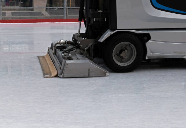 istock Ice resurfacing machine while polishing surface at the open public ice rink. Ice maintenance machine in motion, side view. Close-up. 1302425894