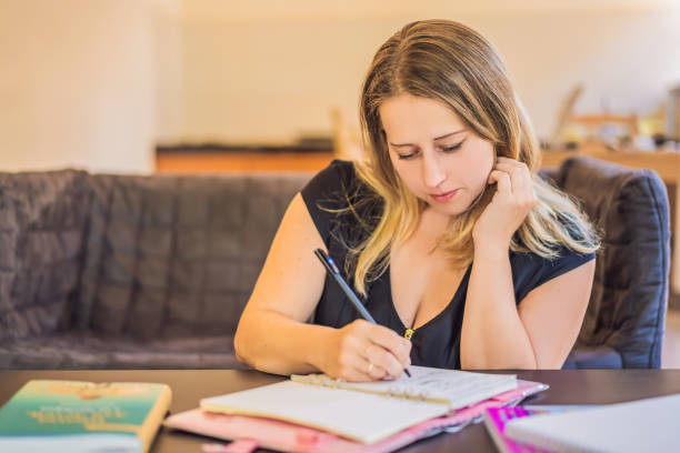 istock Teacher, tutor for homeschooling at the table 1302427804