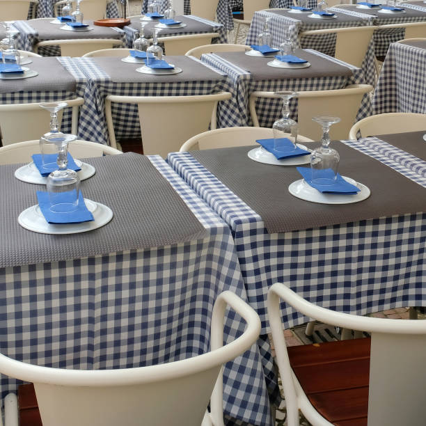 istock Empty served tables on the street in a cafe 1302428150