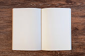 Blank open book on wood background