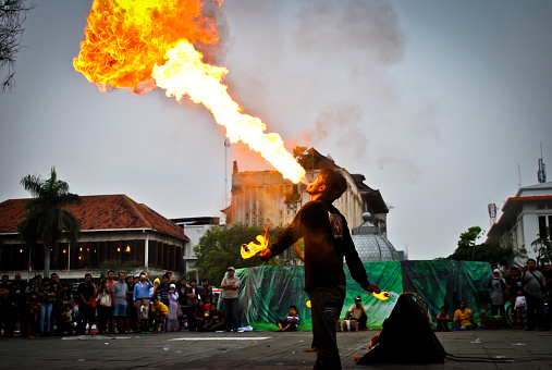 Kota Tua, Central Jakarta, Indonesia - 03 November 2012: In the afternoon when people are relaxing enjoying the atmosphere of the Old City, some people begin to get ready to show off by showing Debus attractions. like blowing fire, showing immunity and so on. Debus is a Sundanese art and culture originating from Banten, West Java, and can even be found in several regions in Indonesia.