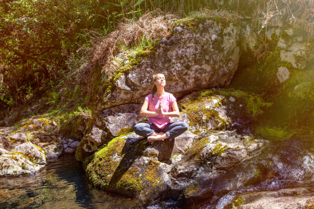 istock Woman meditating in the forest 1302430335