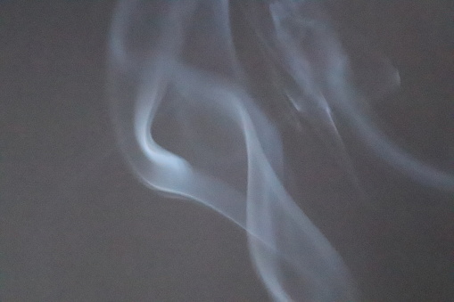 Smoke fumes in close up against black background