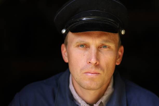 istock Portrait of a young worker in an old uniform 1302432382