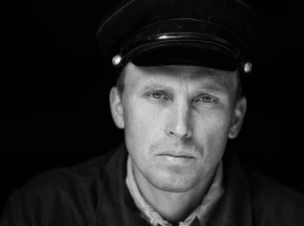 istock Portrait of a young worker in an old uniform 1302432384