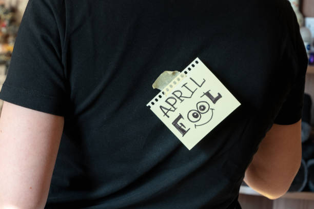 istock Person with funny 1 april fools day sticker on back. 1302433498