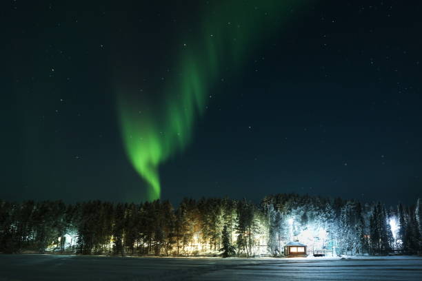istock northern lights over the forest and house 1302433579