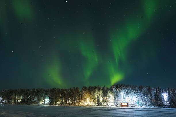 istock northern lights over the forest and house 1302433580
