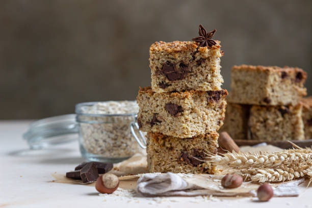 istock Oatmeal squares with chocolate, light concrete background. Diet bars. Healthy bakery for breakfast or dessert. 1302433787