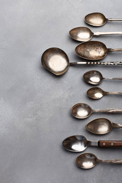 istock Silver vintage spoons on gray concrete background 1302435359