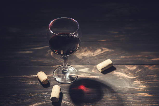 istock glass of wine and corks 1302436226