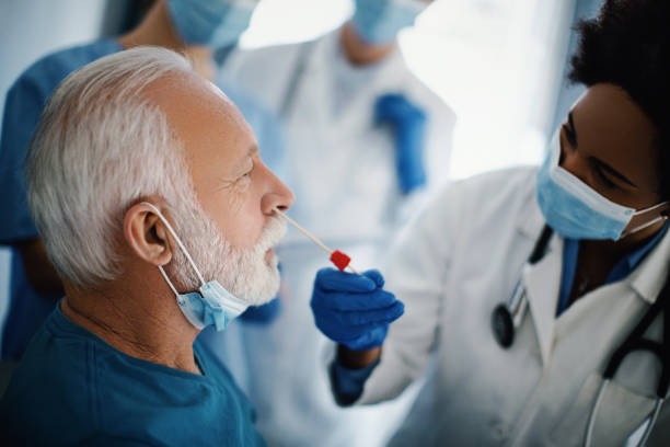 istock Taking nasal swab test from a senior patient. 1302437948