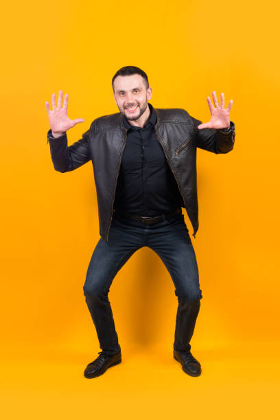 istock Laughing, cheerful man on a yellow background in the studio 1302437957