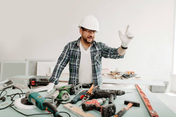 istock A man builder in a protective helmet with tools raised his hand to the top during repairs 1302438100