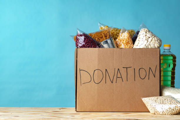 istock Food donations on the table. Text Donation. 1302440977