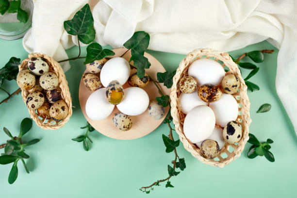istock Flat lay easter composition with green leaves and easter eggs on a green background, Happy Easter, copy space, top view. 1302441243