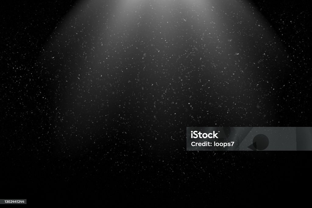Dust Particles / Snowfall in the Light Beam against Black Background Dust Particles Flying in the Air.
Can be used as Overlay with a Blending Mode (screen). Light - Natural Phenomenon Stock Photo