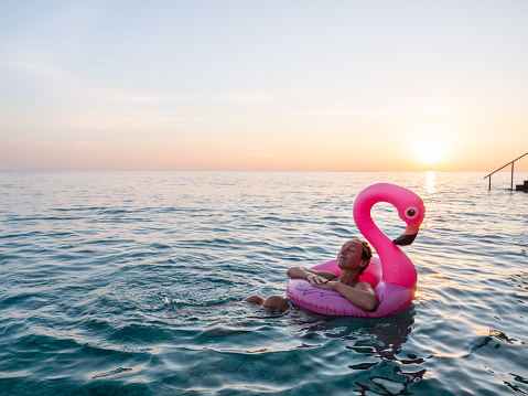 She enjoys sun rising from her overwater bungalow