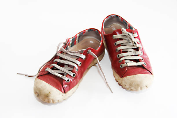 istock old worn red sports sneakers 1302442676