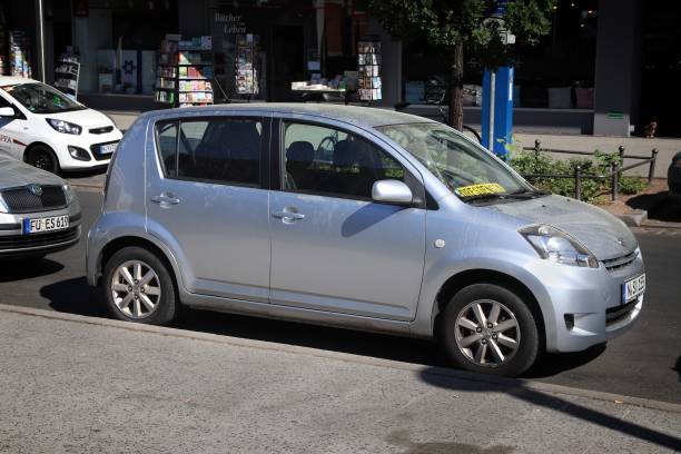Lisbon, Portugal, December 2, 2025, Toyota iq microcar driving on an urban street, showing its compact size for city mobility
