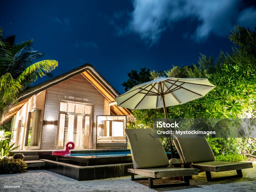 Luxury beach villa at night Night shot of beautiful luxury private villa in the Maldives Vacation Rental Stock Photo