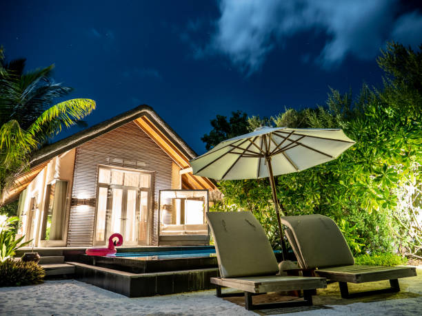 Luxury beach villa at night Night shot of beautiful luxury private villa in the Maldives bungalow stock pictures, royalty-free photos & images