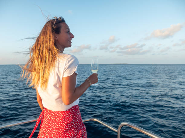 istock Woman enjoys luxury sunset cruise 1302444330
