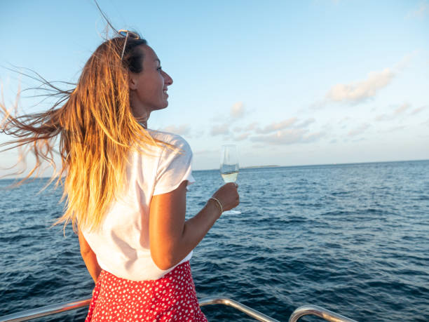 istock Woman enjoys luxury sunset cruise 1302444435