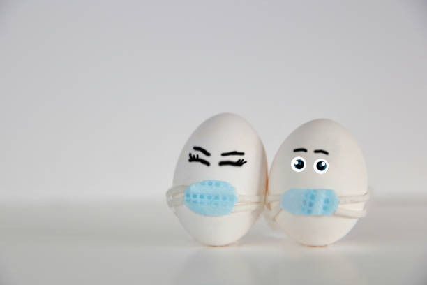 istock Easter eggs with Corona virus COVID19 protection concepts. DIY Do It Yourself easter eggs wearing mask for Easter holidays decoration on white background Selective focus with copy space. COVID-19 protection 1302445736