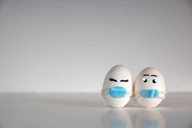 istock Easter eggs with Corona virus COVID19 protection concepts. DIY Do It Yourself easter eggs wearing mask for Easter holidays decoration on white background Selective focus with copy space. COVID-19 protection 1302445781