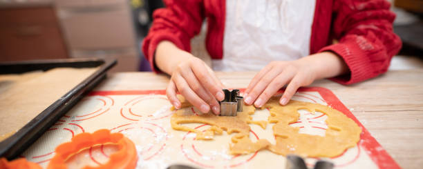 istock Girl making cookies at home 1302445810