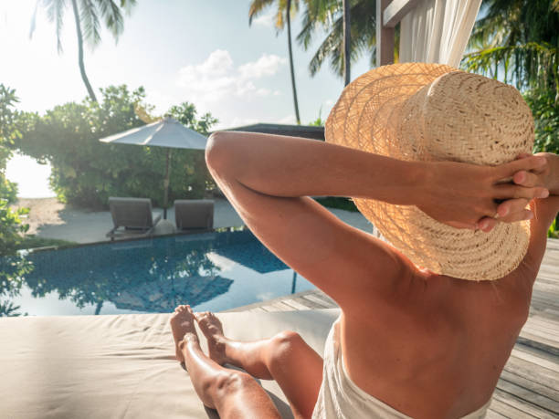 istock Woman relaxing in private pool villa 1302446107