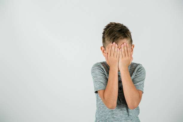 istock Little boy with his hands covering his eyes 1302446377